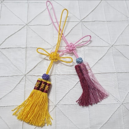 A pair of tassels on a white surface
AI-generated content may be incorrect.